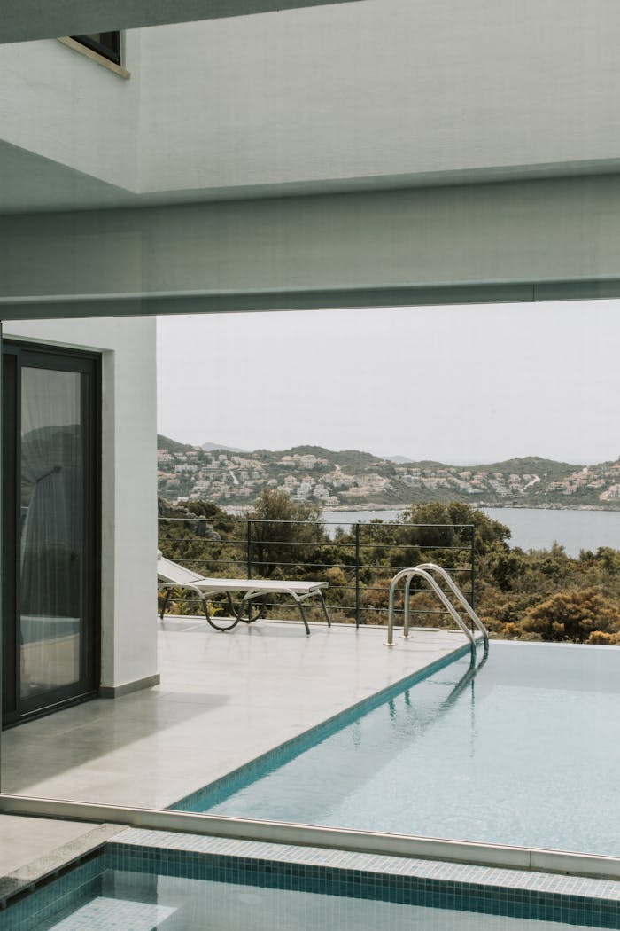 Modern villa pool area with stunning sea and mountain views in Antalya, perfect for relaxation.
